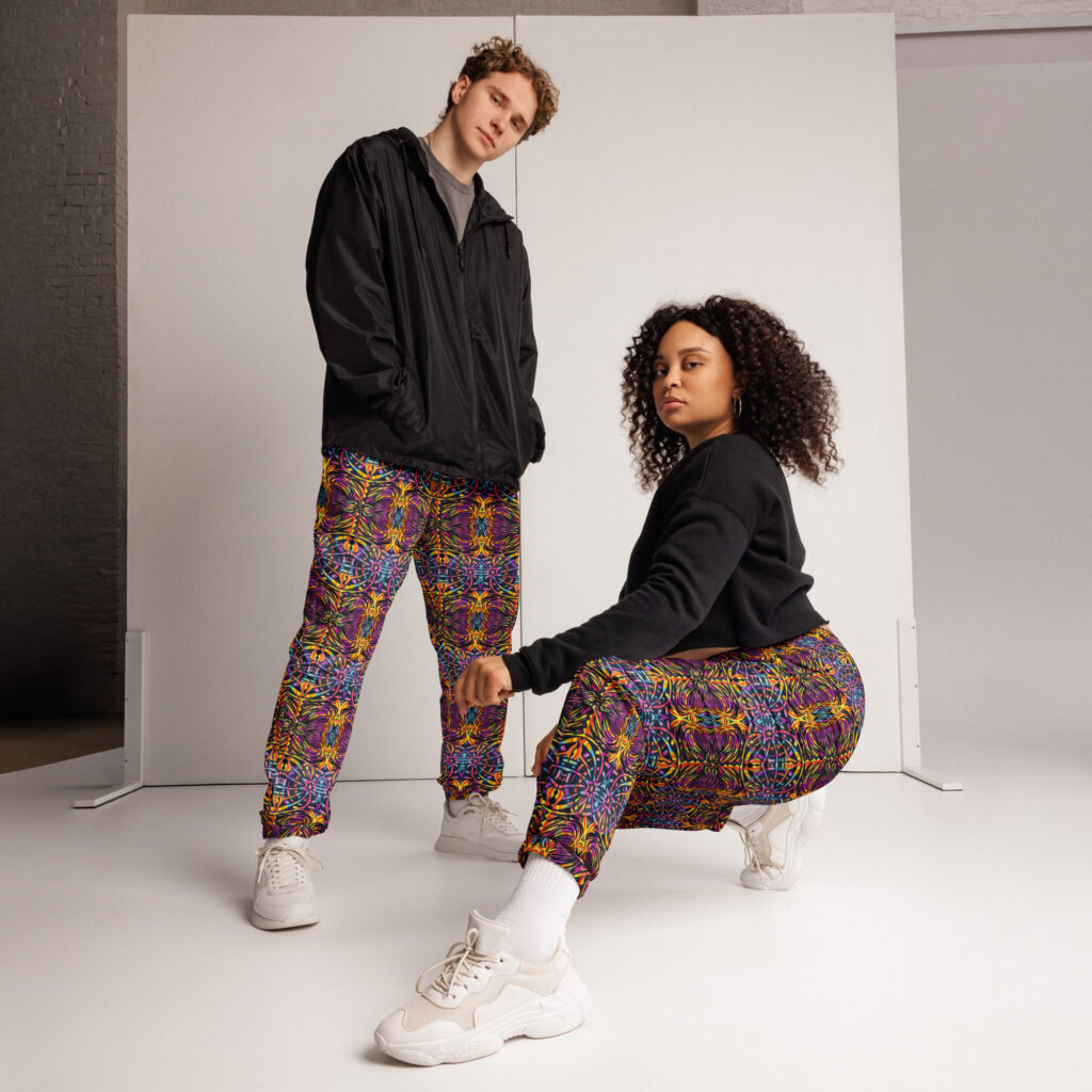 two models wear track pants with the smaller sized BoomBoom print, designed from artwork from the book: SCared Bear Art & Inquiry.
