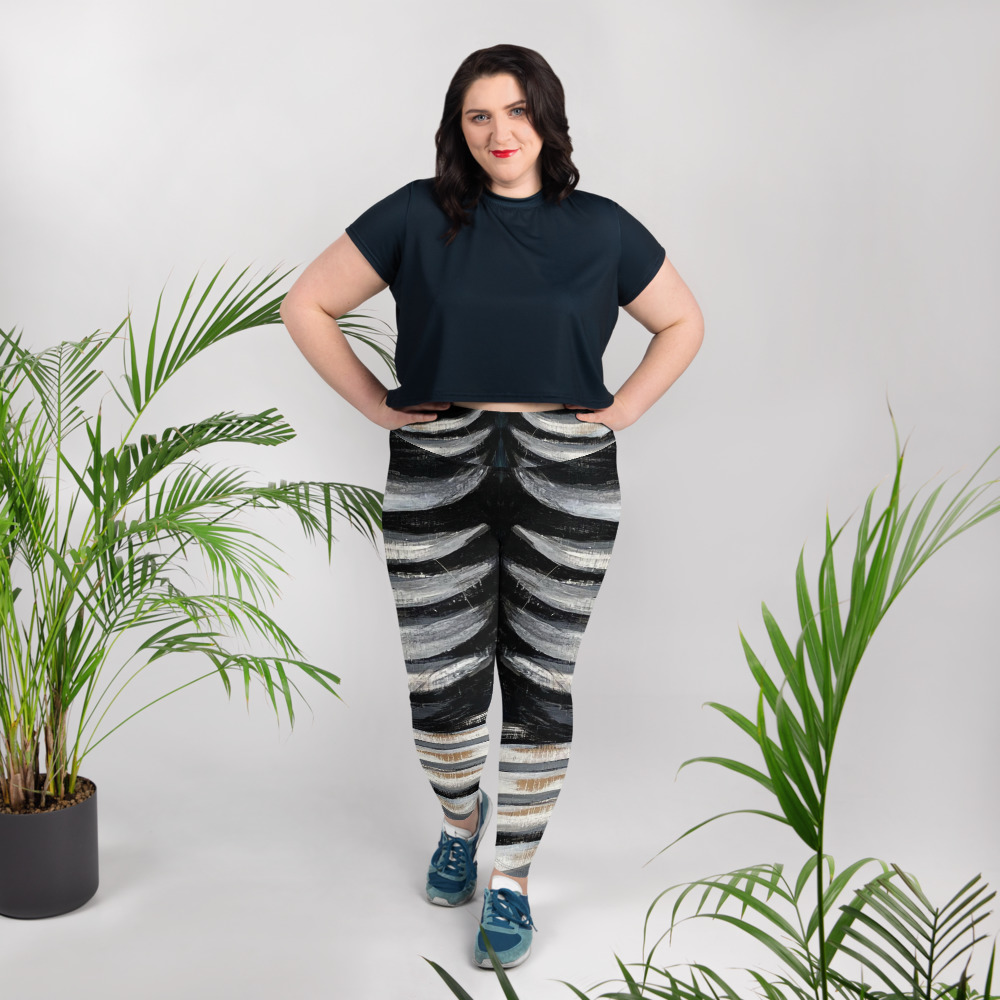 High‑waisted leggings with bold claw‑mark pattern in black, white, and teal tones, inclusive sizing.