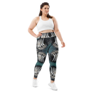 Plus‑size model wearing black, white, and teal bear‑claw patterned leggings with white crop top