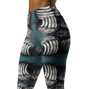 A woman in high waist with a wide waist band yoga leggings. White and black bear claws on a deep green background create a mirror pattern.