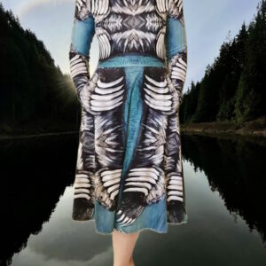 Front view of dress shows flattering sculptural framing of bear claw design. Teal midi dress with mirrored bear‑claw pattern in white, grey, and black With pockets. Model wears size S.