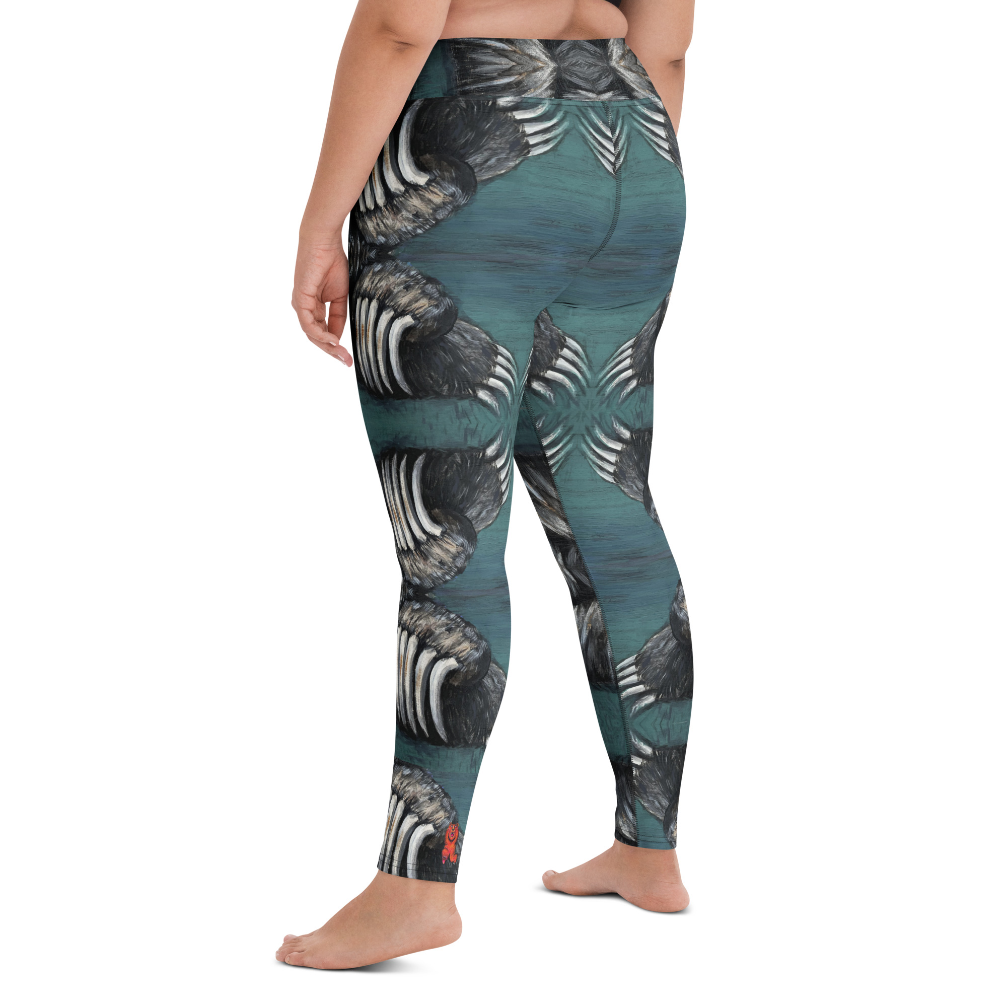 A woman in high waist with a wide waist band yoga leggings. White and black bear claws on a deep green background create a mirror pattern with 360 degrees of fashion designed by Tanya Tee Art_TLC.