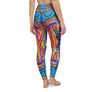 Model wearing regular‑fit Kelpies yoga leggings featuring a vibrant multicolo design of stylized kelpie horse heads in pink, yellow, orange, and purple, arranged in a symmetrical composition against a swirling blue background, with an ornate patterned waistband in red, blue, and orange. Where landscape, myth and fashion breathe.