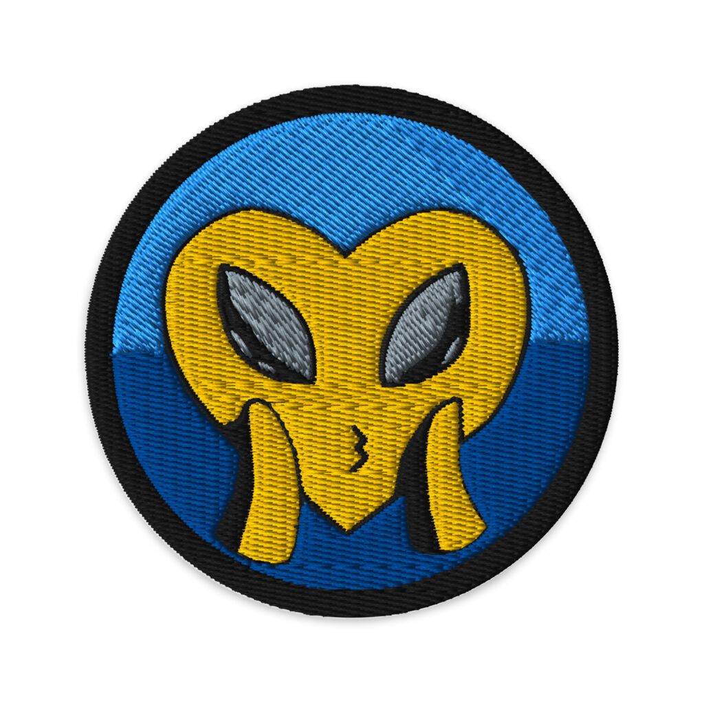 The yellow heart face blowing a kiss with cute loving alien eyes reminds us Love is Universal. This unique patch is designed by Tanya Tee Art_TLC from her original